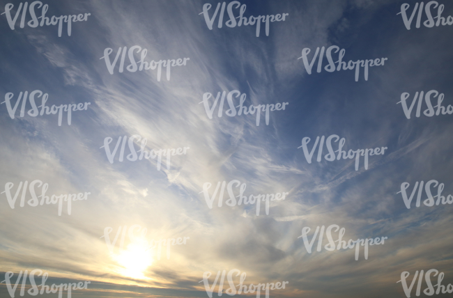 sky with sun setting behind cirrus clouds