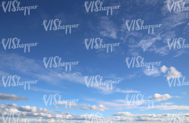 daytime sky with a stripe of clouds near horizon