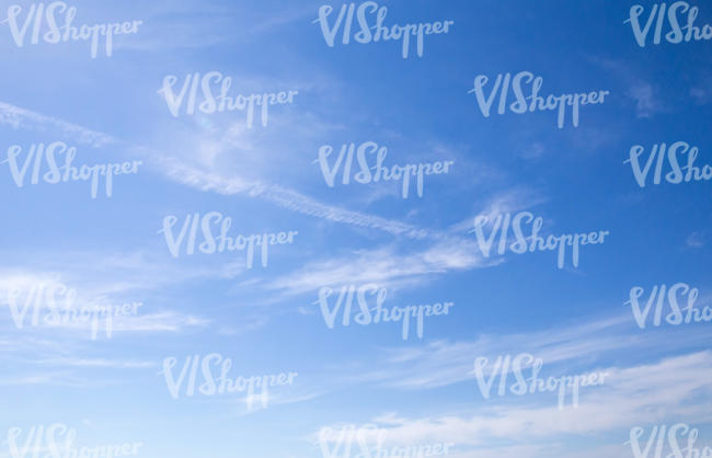 blue sky with few thin clouds