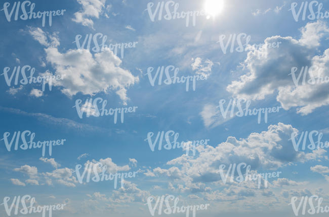 daytime sky with sun and white clouds