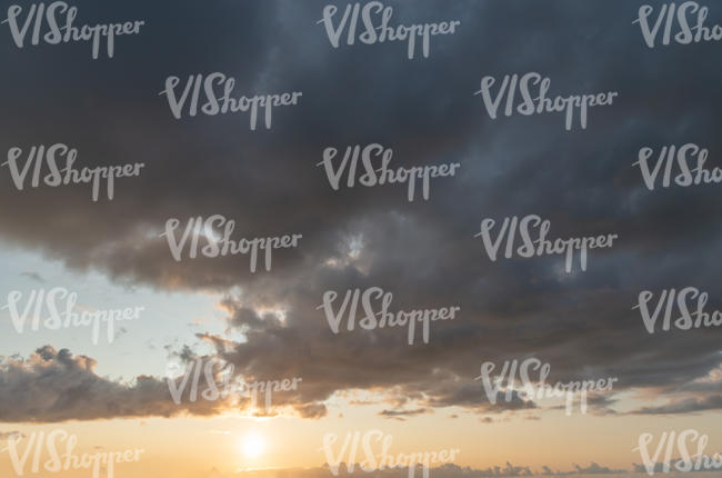 sunset with sun and dark clouds