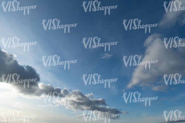 daytime sky with some oblong clouds