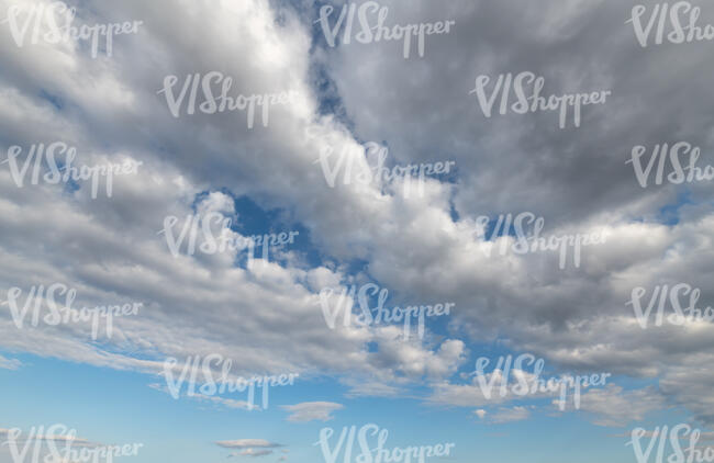 pale blue daytime sky with large white clouds