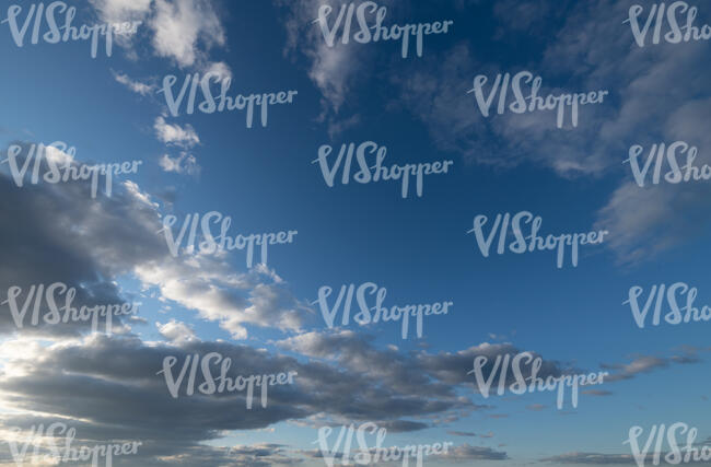 deep blue sky with greyish clouds
