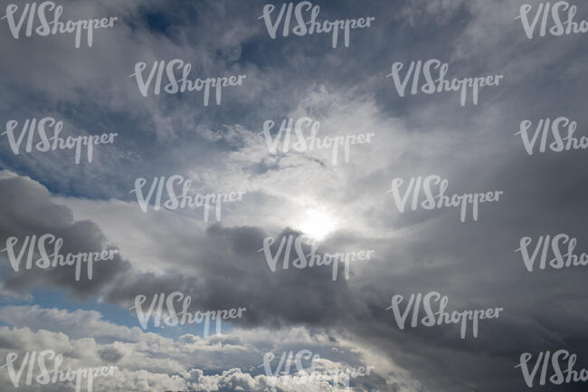 very cloudy sky with sun visible between clouds