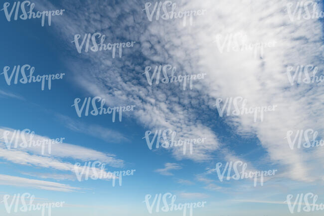 blue sky with a strip of white clouds