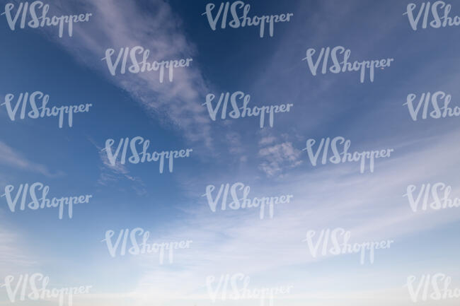 blue sky with few thin clouds