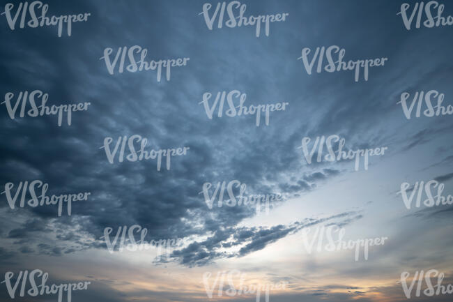 sunset sky with dark scattered clouds