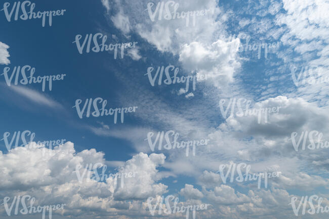 daytime sky with mixed type white clouds