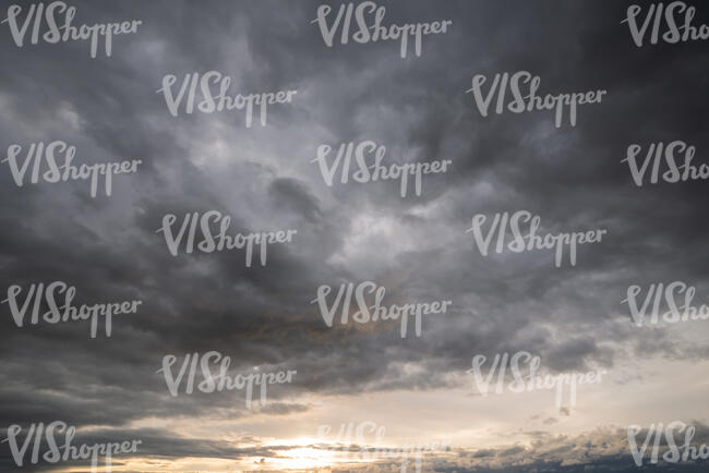 sunset with large grey clouds