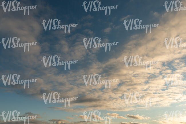 evening sky with warm sunlight reflecting on the clouds