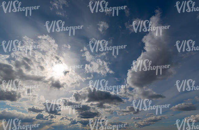 sky with small clouds and sun