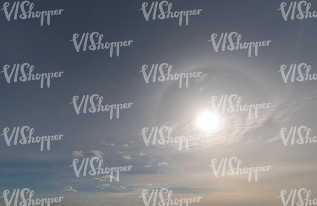 daytime sky with sun and halo