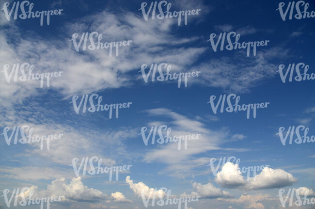 dark blue daytime sky with small white clouds