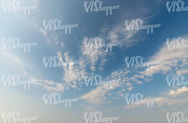 daytime sky with small thin scattered clouds