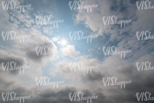 daytime hazy sky with sun and clouds