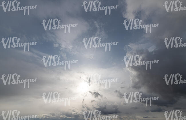 daytime sky with sun shining through a thin cloud