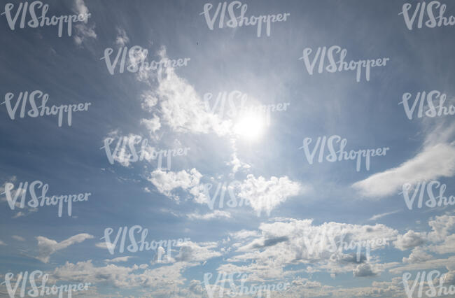 daytime sky with sun and small clouds