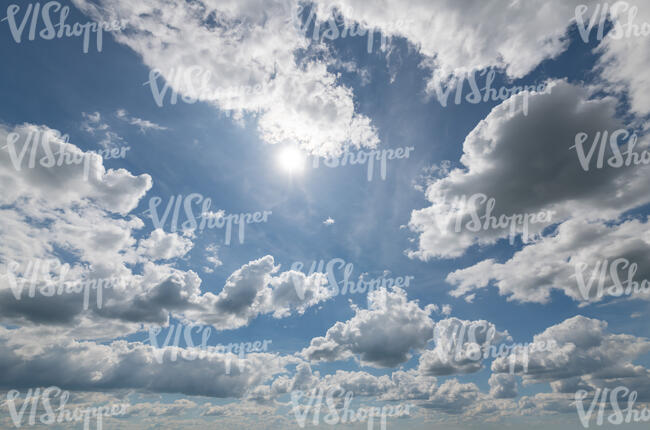 daytime sky with sun and clouds