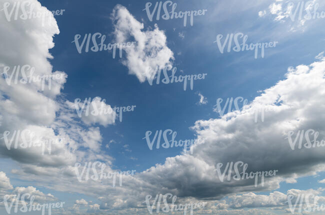 daytime sky with large white clouds