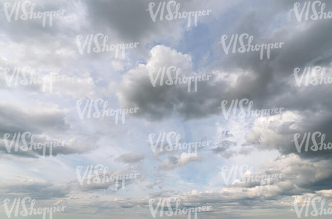 pale blue sky with greyish clouds