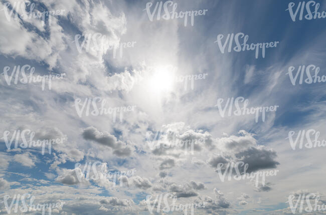 daytime sky with sun behind thin clouds