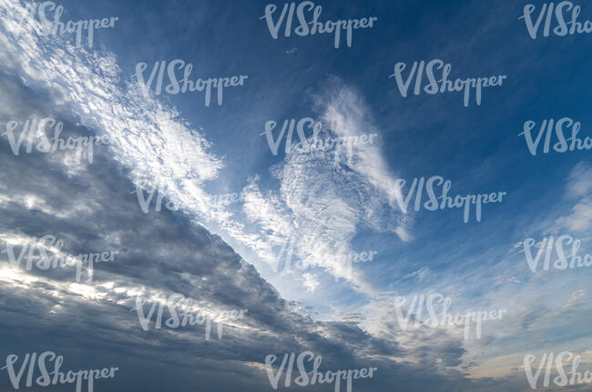 deep blue sky with dark row of clouds