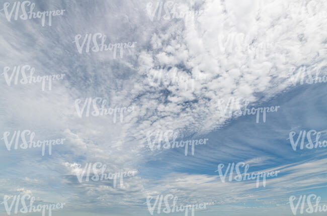sky covered with thin small white clouds