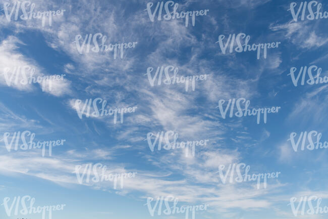 daytime sky with thin clouds floating around