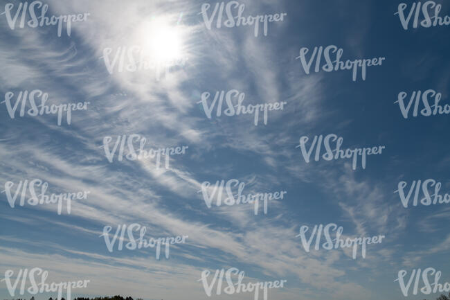sky with cirrus clouds and sun slightly visible