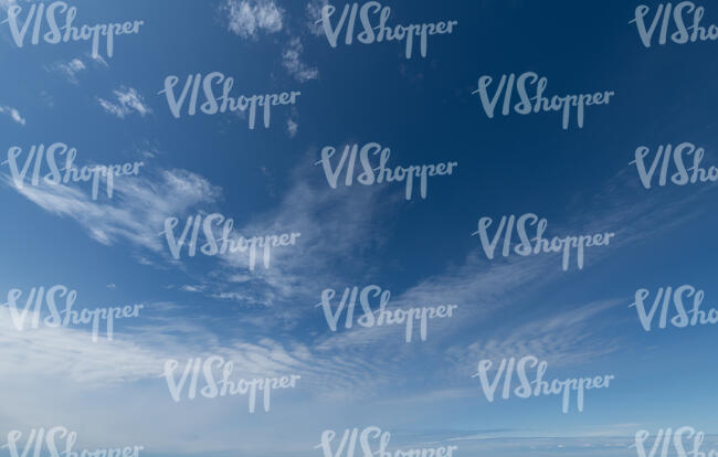 bright blue sky with few thin clouds