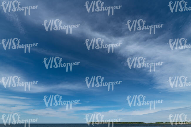 deep blue sky with white cirrus clouds
