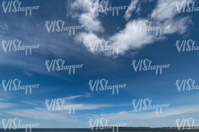 deep blue sky with little white clouds