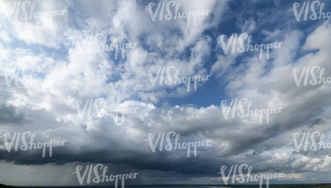 blue sky with an incoming rain cloud