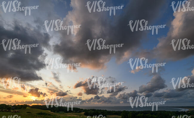 sunset with sun and large clouds