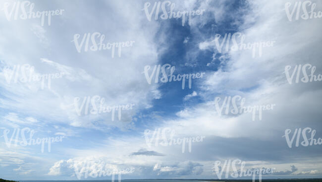 sky almost covered with thin white clouds