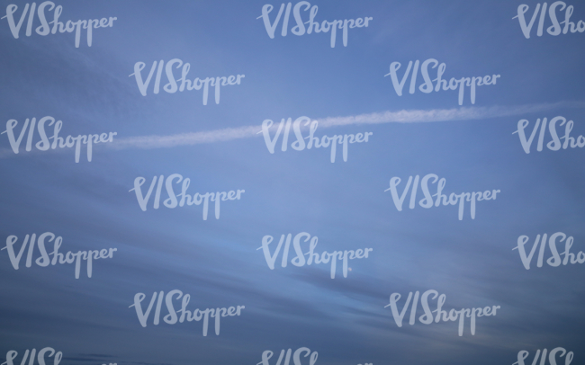 evening sky with puprle clouds and contrails