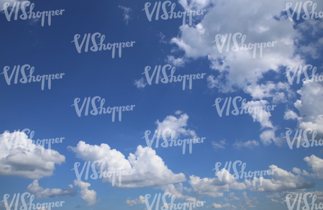 blue daytime sky with some white fluffy clouds