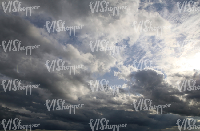 sky with sun shining through rain clouds