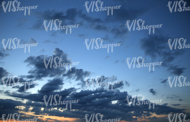 sunset sky with some dark blue clouds