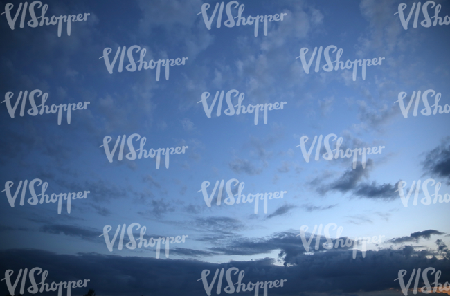 deep blue evening sky with dark clouds