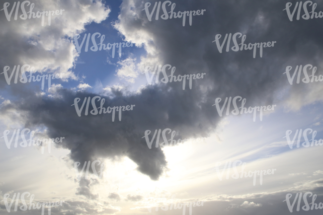 daytime sky with sun shining between the clouds